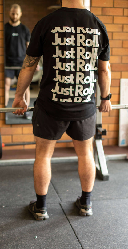 Athlete in gym, deadlifting in black and white brazilian jiujitsu t-shirt