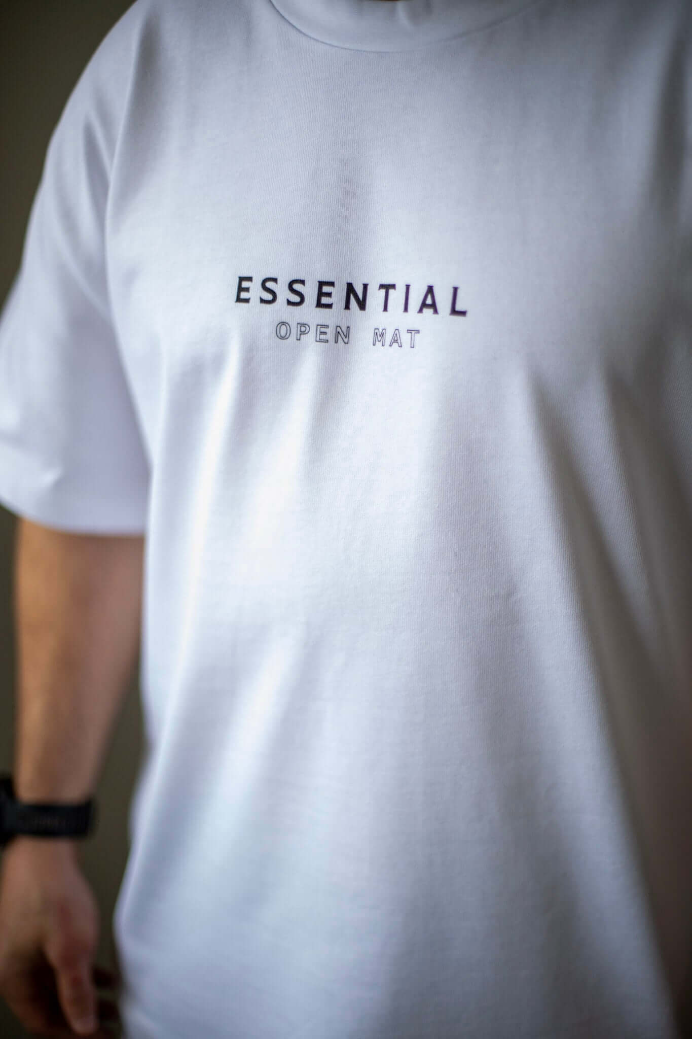 Close up of man in white and black brazilian jiujitsu t-shirt