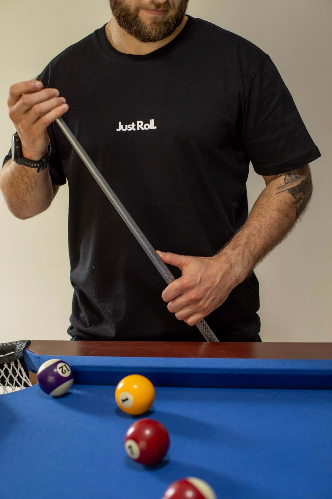 Man with pool cue and pool tabel in black and white brazilian jiujitsu t-shirt