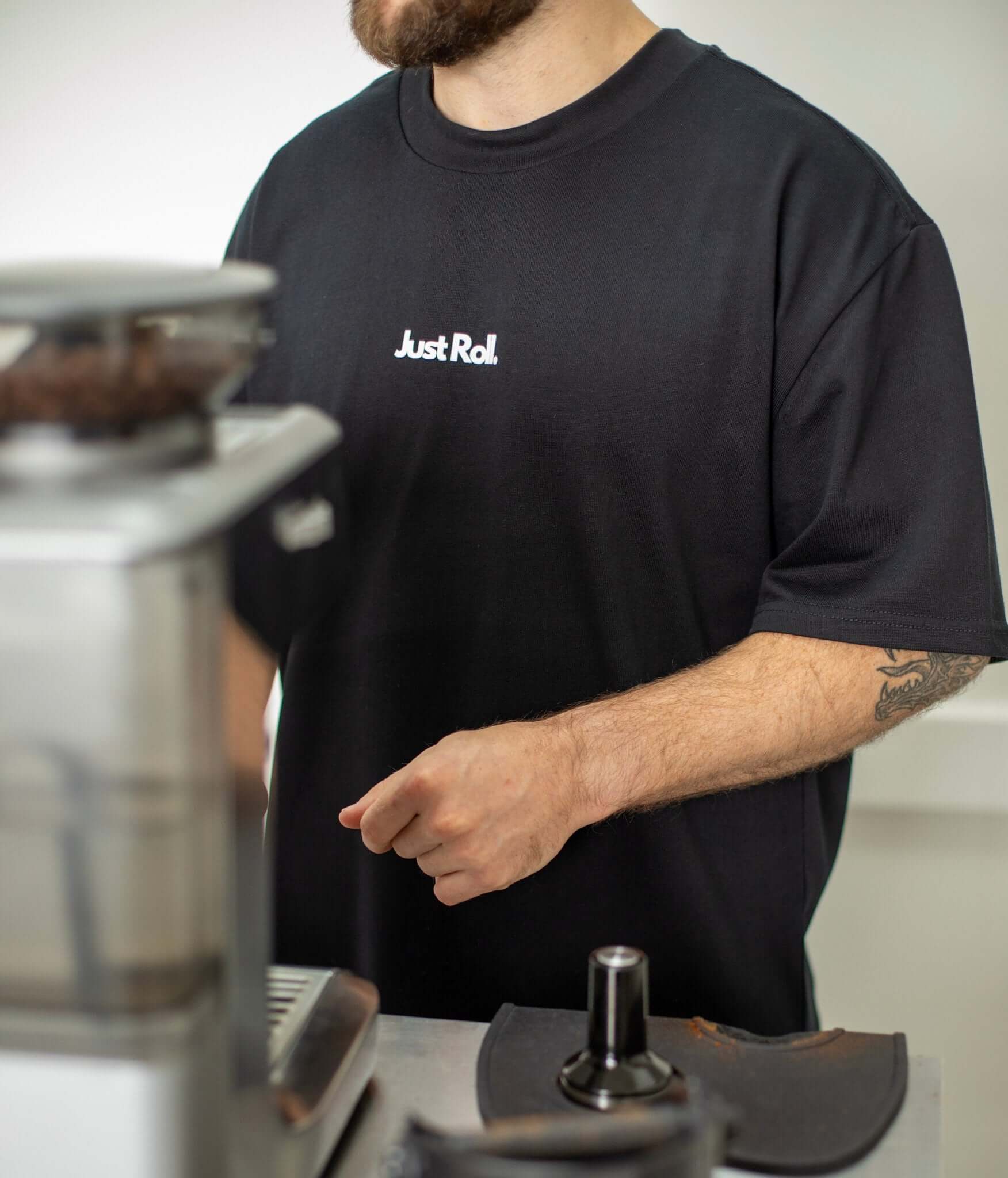 Man making a coffee in black and white brazilian jiujitsu t-shirt